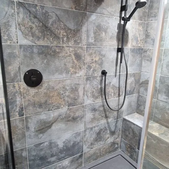Stone-effect walk-in shower with matt black fittings